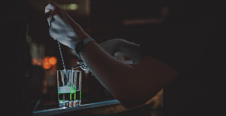 bartender making collection of colorful shots. Set of cocktails at the bar