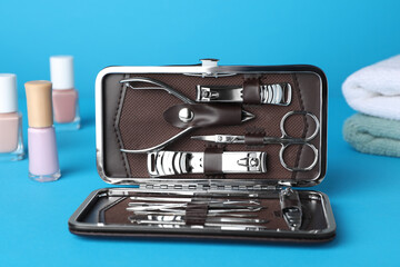 Manicure set in case on light blue background
