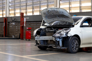 car in automobile repair service center with soft-focus and over light in the background