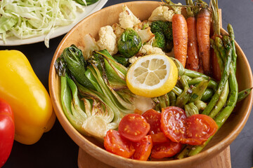 Vegan protein source. Buddha bowl dish, avocado, pepper, tomato, cucumber, red cabbage, chickpea, fresh lettuce salad and walnuts, nuts, beans, . Healthy vegetarian eating, super food. Top view.