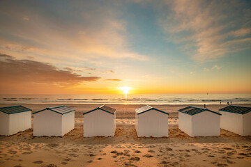 Beachhouses at the beach on Texel island in the Netherlands during sun set. - obrazy, fototapety, plakaty