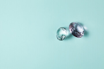 Precious gemstones for design gems jewellery. Diamonds crystal on turquoise background.