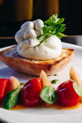 Salad with Tomatoes, honey pear and Burrata cheese with basil and olive oil on wooden background