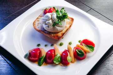 Salad with Tomatoes, honey pear and Burrata cheese with basil and olive oil on wooden background