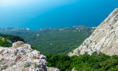 Fototapeta na wymiar View of the Black Sea coast from a high cliff of the South Coast of Crimea.