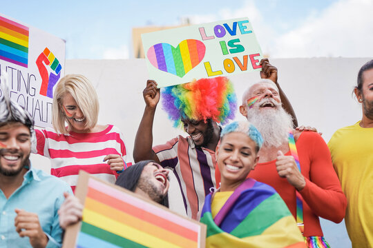 People from different generations have fun at gay pride parade with banner - Lgbt and homosexual love concept