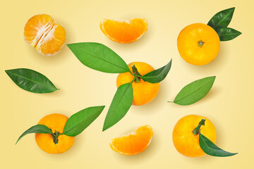 Tangerine or mandarin fruit with leaves isolated on yellow background.