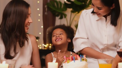 Young transgender couple with flowers on color background. Valentine's Day celebration.