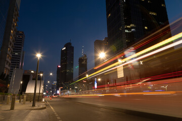 Night traffic lights in downtown Jakarta, between office skyscrapers, Thamrin street