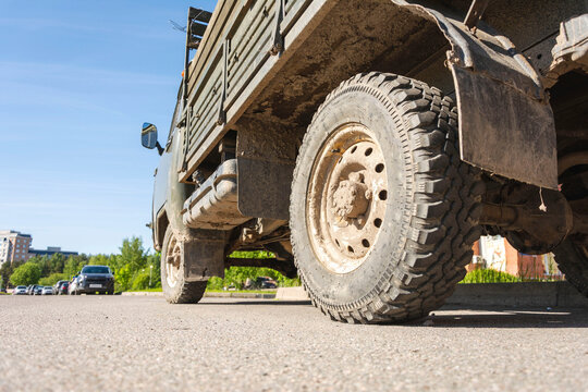 Dirty SUV Truck In The Parking Lot In The City In The Summer, Bottom View Of The Transmission And Gas Tank, Russia 2021