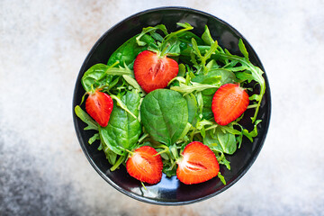 salad strawberry green leaves mix arugula, spinach organic healthy food meal snack copy space food background rustic. top view vegan or vegetarian food