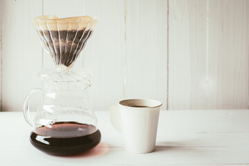  coffee drip on jug and mug with equipment, tool brewing at kitchen home white of wooden background. nopeople