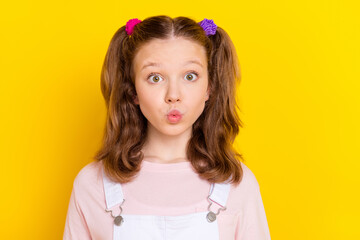 Photo portrait schoolgirl with tails sending air kiss isolated bright yellow color background