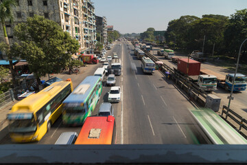 Afternoon traffic of heavy trucks, buses and cars in Yangon city, over Strand Road