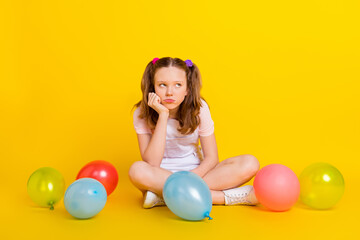 Fototapeta na wymiar Full length body size photo schoolgirl at party with balloons moody grumpy sad isolated vibrant yellow color background