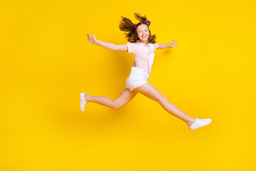 Fototapeta na wymiar Full length body size photo schoolgirl jumping up careless isolated bright yellow color background