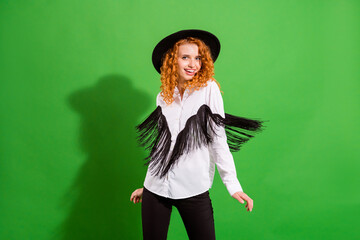 Portrait of attractive cheerful wavy-haired girl dancing moving having fun holiday isolated over bright green color background