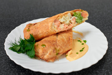 Puff pastry roll stuffed with salmon and broccoli