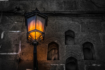 Fototapeta na wymiar A luminous lamp in one of the alleys of old Sana'a City, Yemen. 