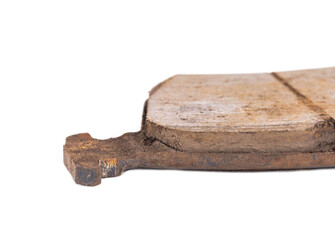 Fototapeta premium Old worn out brake pads from a car on a white background, isolate, close-up. Quality of friction linings, modern auto parts