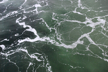 Surface of sea with foam.
