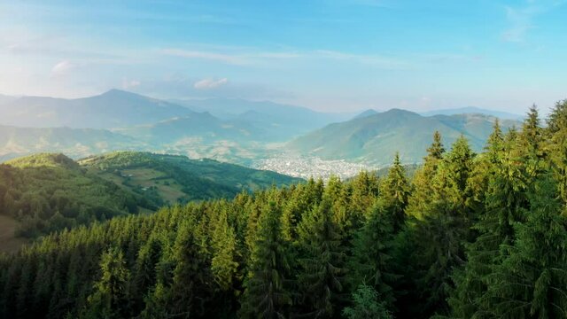 Flying above mountain resort, summer landscape in relaxing small mountain village in Romania
