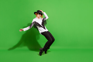 Profile full size photo of sweet orange hairdo lady dance wear eyewear hat shirt trousers isolated on green background