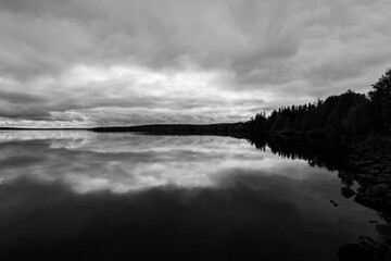 Fototapeta premium Dramatic autumn clouds reflection in Muonio lake, Lapland, Northern Finland