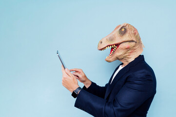 Man with dinosaur mask.blue background