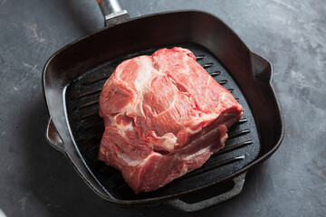 piece of raw meat in a frying pan