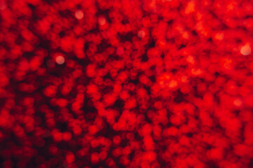 Fototapeta na wymiar Abstract shiny blurred red background. Textured glittering backdrop for your projects. Copy space