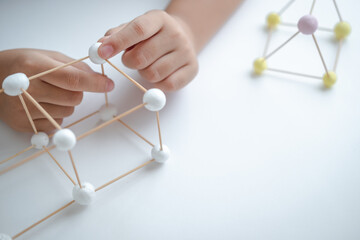 STEM education, Child learning making 3D geometric shapes, Building Structure.