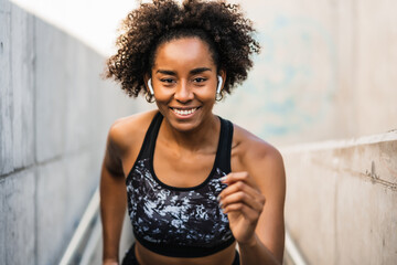 Fototapeta premium Afro athlete woman running outdoors.
