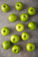 ripe green apples on gray concrete