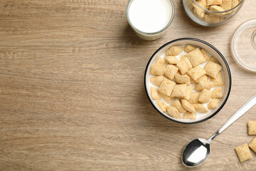 Tasty corn pads with milk served on wooden table, flat lay. Space for text