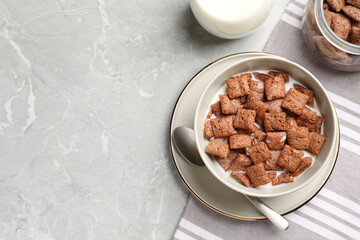 Tasty corn pads with milk served on light grey marble table, flat lay. Space for text