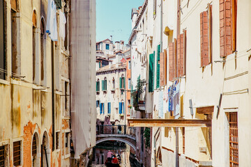 Fototapeta na wymiar Gondola on canal in Venice. The charm of Italy.
