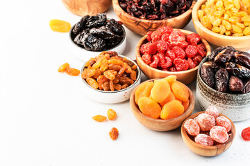 Healthy food snacks: natural dried fruits mix in bowls on white background