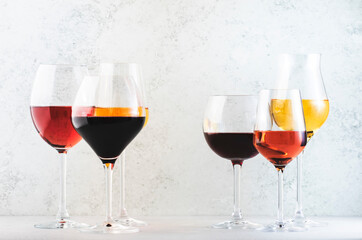 Wines assortment. Red, white, rose wine in wineglasses on gray background. Wine bar, shop, tasting...