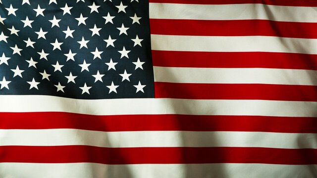 Grunge american flag waving, close-up.