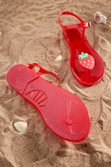 Red flip flops on the sand