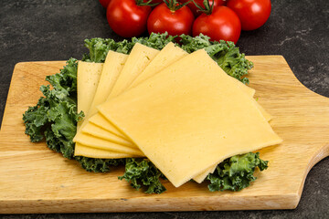 Sliced Gauda cheese over board