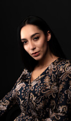 portrait of a young woman in the studio on a dark background