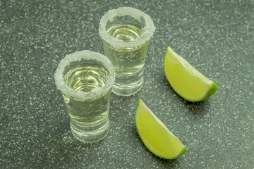 The glasses are filled with tequila and lime and salt