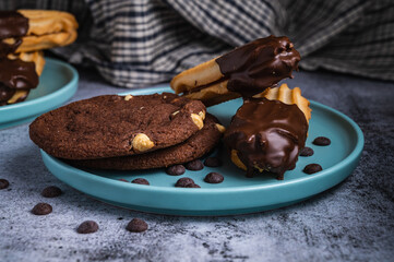 Dark chocolate coated digestive biscuit with chocolate cookies and chips for loved ones valentines day celebration. Partially eaten