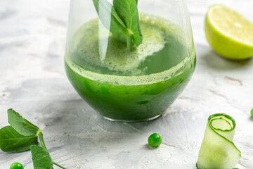 Healthy Detox Drink. Healthy smoothie with green leaves of kale green fresh peas, cucumber, spinach and lime