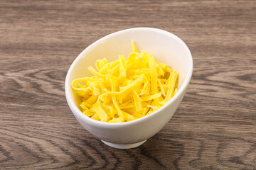Shredded yellow cheese in the bowl