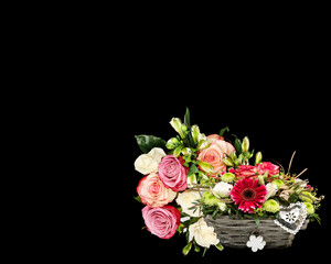 Bouquet of roses and chrysanthemums in woven bamboo baskets isolated on black background with​ clipping​ path​