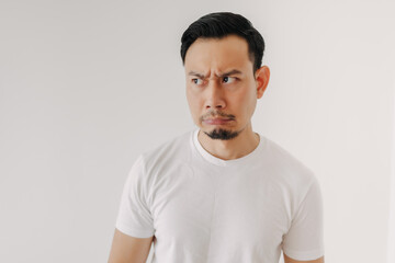 Grumpy face Asian man in white t-shirt isolated on white background.