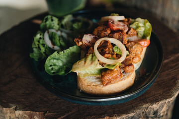 Toast with crispy fried spicy chicken, onion and sause